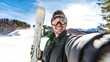 © Davide Angelini - Happy skier taking selfie pic with smart cell phone device outside - Young man having fun on weekend activity in ski resort vacation - Winter sport concept