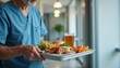 © Volha - Nurse serving meal tray with chicken, fries, and drink in hallway, hospital food tray