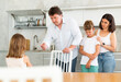 © JackF - Mom and dad scold their guilty daughter standing in kitchen at home