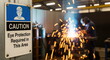 © CK Studio - Industrial safety sign for eye protection in a workshop, with a welder producing sparks. Highlights workplace safety and hazardous work.