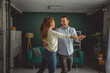 © Miljan Živković - Happy couple dancing enjoying romantic moment at home