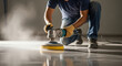 © Bakha - Worker polishing concrete floor with power grinder in industrial interior, closeup of hands in protective gloves cleaning surface with machine and creating smooth reflective finish