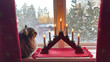 © LenaLensLife - Swedish advent ljusstake, traditional candle holder with warm candlelight in a snowy winter window, with a tabby cat nearby