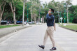 © crizzystudio - Businessman talking on phone walking on crosswalk in city