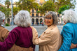 © unai - Group of senior friends walking in city looking back