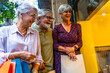 © unai - Senior friends enjoying window shopping with bags