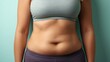 © Anat art - Female Abdomen Showing Soft Fat Folds Before Weight Loss Against a Neutral Pastel Background in a Professional Stock Style