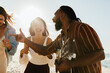 © (JLco) Julia Amaral - Friends enjoying music and laughter on a sunny beach day