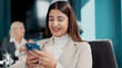© FlexOn/peopleimages.com - Business woman, reading and planning with phone in meeting, review agenda and boardroom gathering. Online resources, digital programme and happy manager prepare for workshop, research info and typing
