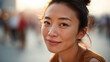 © JAYDA RIN - Young woman smiling with natural makeup and freckles in soft sunlight, expressing calm and warmth