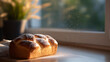© perfectlab - Freshly baked braided bread loaf dusted with powdered sugar on wooden surface near window with natural light