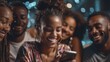 © maxximmm - A woman of African descent engages with her group of friends who are gathered lively around her, all watching something together on a smartphone. The friends share smiles and laugh