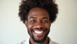 © miss irine - Happy young african american man with afro hair smiles wide with perfect white teeth. Confident male model with beautiful healthy smile. Person portrait after dental care whitening procedure isolated