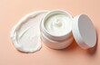 © miss irine - White cosmetic cream jar open next to a smooth swirl texture of the face mask product. This beauty care item offers skin moisturizing and purifying benefits for healthy glow.