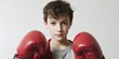 © Andrii Zastrozhnov - Young caucasian male child with red boxing gloves in confident stance