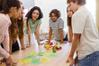 © Robert Kneschke - Group of students discussing healthy food options in a school setting
