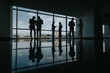 © qunica.com - Colleagues stand in an office lobby with large windows. Conversations and gatherings unfold against the city view. The glossy floor reflects the silhouettes, creating a calm, professional atmosphere.