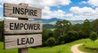 © TensorSpark - Wooden signpost reading 'inspire, empower, lead' on a countryside trail symbolizing coaching, mentoring, guidance and leadership direction.