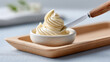 © Sergey - Creamy butter texture with wooden spatula on tray for culinary design