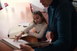 © Taras Grebinets - Child Learning With Adult Helping During Library Study Session