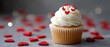 © pvl0707 - Delicious valentines day cupcake decorated with red hearts set against a blurred background for elegant presentation and copy space