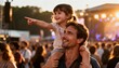 © Running opossum - father with daughter on shoulders at summer festival enjoying music under setting sun