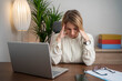 © Nenad - Business woman having headache at office