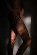 © RooM The Agency - Close-up side view of a woman's legs with shadows on