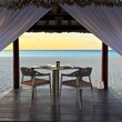 © RooM The Agency - Private dining table set up in a beach cabana at sunset, Eagle Beach, Aruba