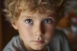 © Studicon - Close up portrait of a young boy with curly hair and thoughtful expression