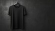 © Design Everytime - Plain black t shirt hanging on a dark textured wall