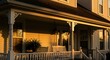 © sea sae - Radiant golden light bathes a charming suburban house porch, highlighting intricate architectural details and fostering a serene, welcoming ambiance at sunset