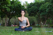 © leungchopan - Woman practicing calm pranayama breathing exercise at park