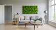 © Norah Allen - A modern living room features a textured green moss wall art above a light gray sofa a wooden coffee table with books and a potted plant and a contemporary floor lamp by a large window