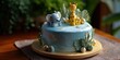 © Iryna - Blue safari-themed cake with elephant and giraffe toppers in natural setting
