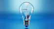 © Xenia - Green energy initiative features light bulb filled with miniature wind turbine and solar panel. Green energy sources represent sustainability,