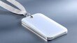 © Adinda - A blank white rectangular ID badge with a silver metal trim and a white ribbon is displayed on a smooth, reflective gray surface. The lighting is soft and diffu