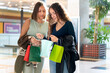 © Alfonso Soler - Spanish gen z women shopping together at modern mall