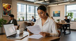 © gabriel - Modern businesswoman reviewing contract in sunlit office, fostering teamwork and professional growth in a collaborative workspace, promoting success and efficiency