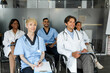 © Prostock-studio - Multiracial group of doctors concentrated men and women in workwear attending medical conference at clinic, sitting on chairs and looking at copy space, listening to speaker, taking notes