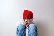 © Sabphoto - Sad Teenager in Santa Hat