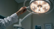 © Tamaras Pictures 4U - Surgeon adjusting bright operating room light before procedure