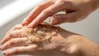 © RisaFitri - Hands exfoliating with natural scrub for soft skin.