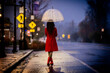 © Connect Images - Woman in red coat and boots walks with umbrella on rainy street at dusk. WA, USA