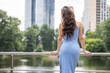 © Andrey_Arkusha - Young beautiful brunette woman in blue knitted dress posing in summer park