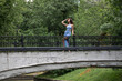 © Andrey_Arkusha - Young beautiful brunette woman in blue knitted dress posing in summer park