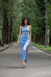 © Andrey_Arkusha - Young beautiful brunette woman in blue knitted dress posing in summer park