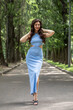 © Andrey_Arkusha - Young beautiful brunette woman in blue knitted dress posing in summer park