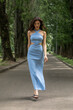 © Andrey_Arkusha - Fashion portrait of a young beautiful brunette woman in blue knitted dress posing in summer park