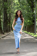 © Andrey_Arkusha - Young beautiful brunette woman in blue knitted dress posing in summer park